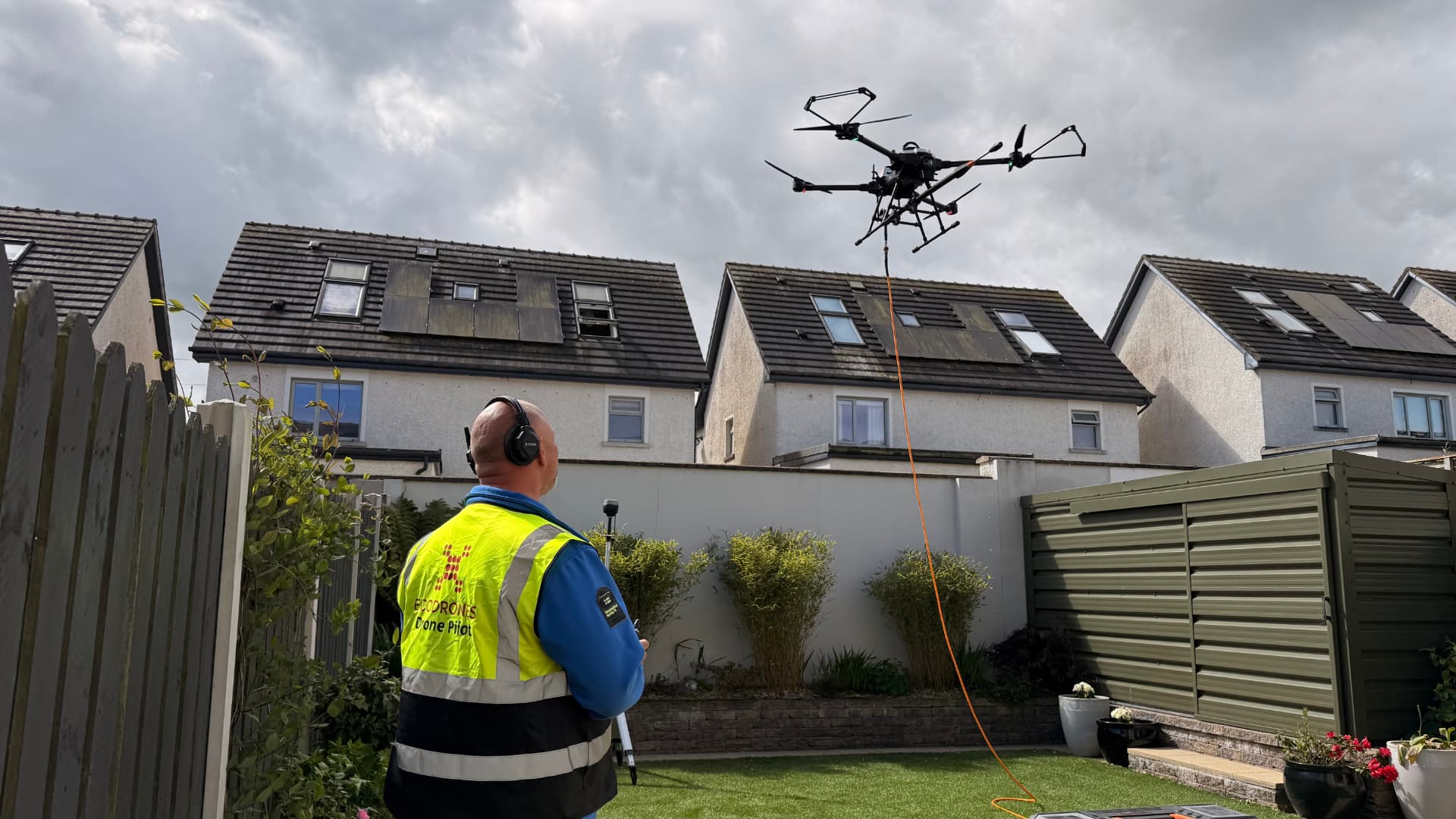 Ecodrones certified pilot operating a multirotor aircraft on a live residential job